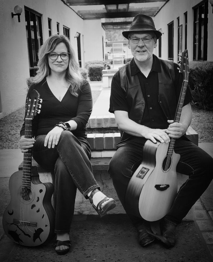 Maija and James sitting with their guitars outside of the thomas collett vocal studio in phoenix