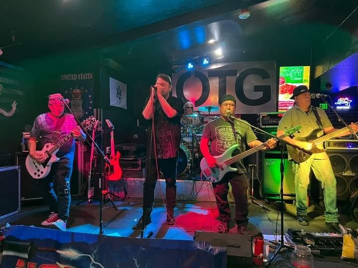 Thomas Collett performing on stage with his local Phoenix band Hotwired