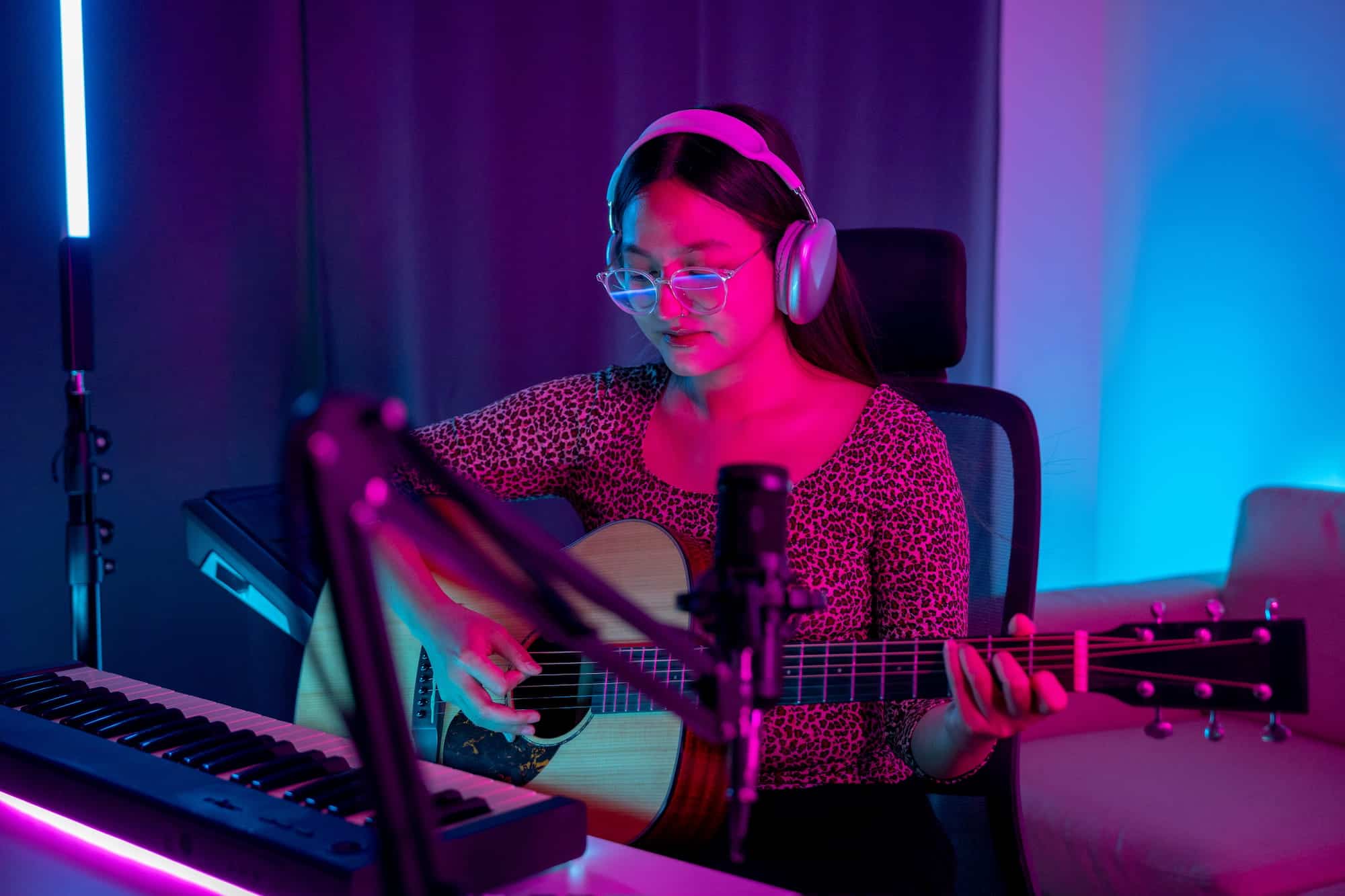 Woman playing guitar and singing at home